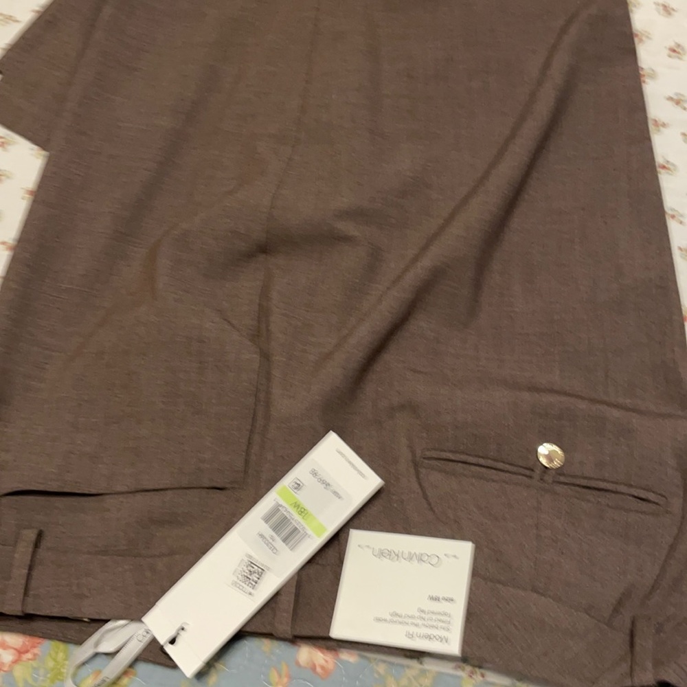 Two Calvin Klein suits. One brown one black
